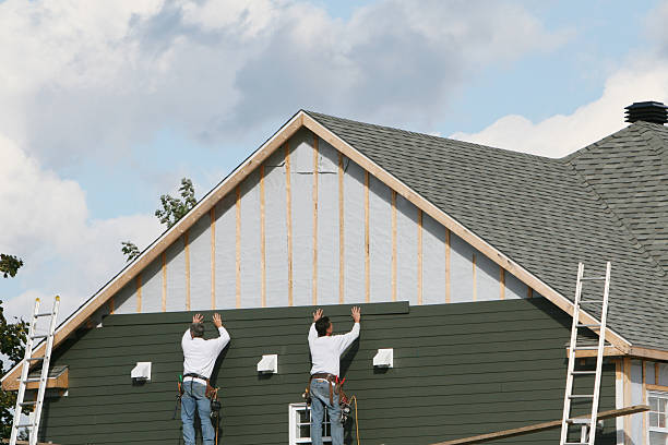 Professional Storm Damage Siding Repair technician working in Hudson, IL